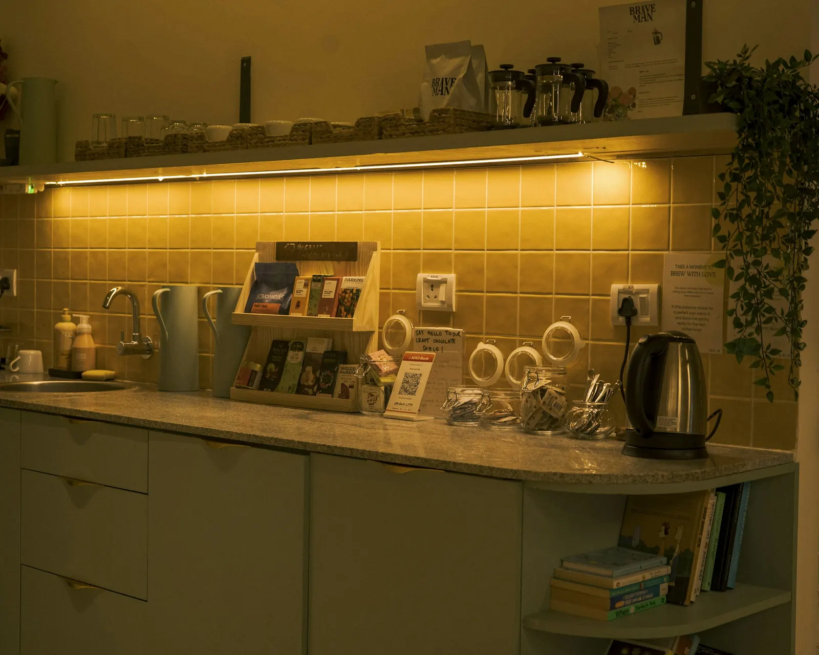 An office break room counter with a kettle and tea supplies