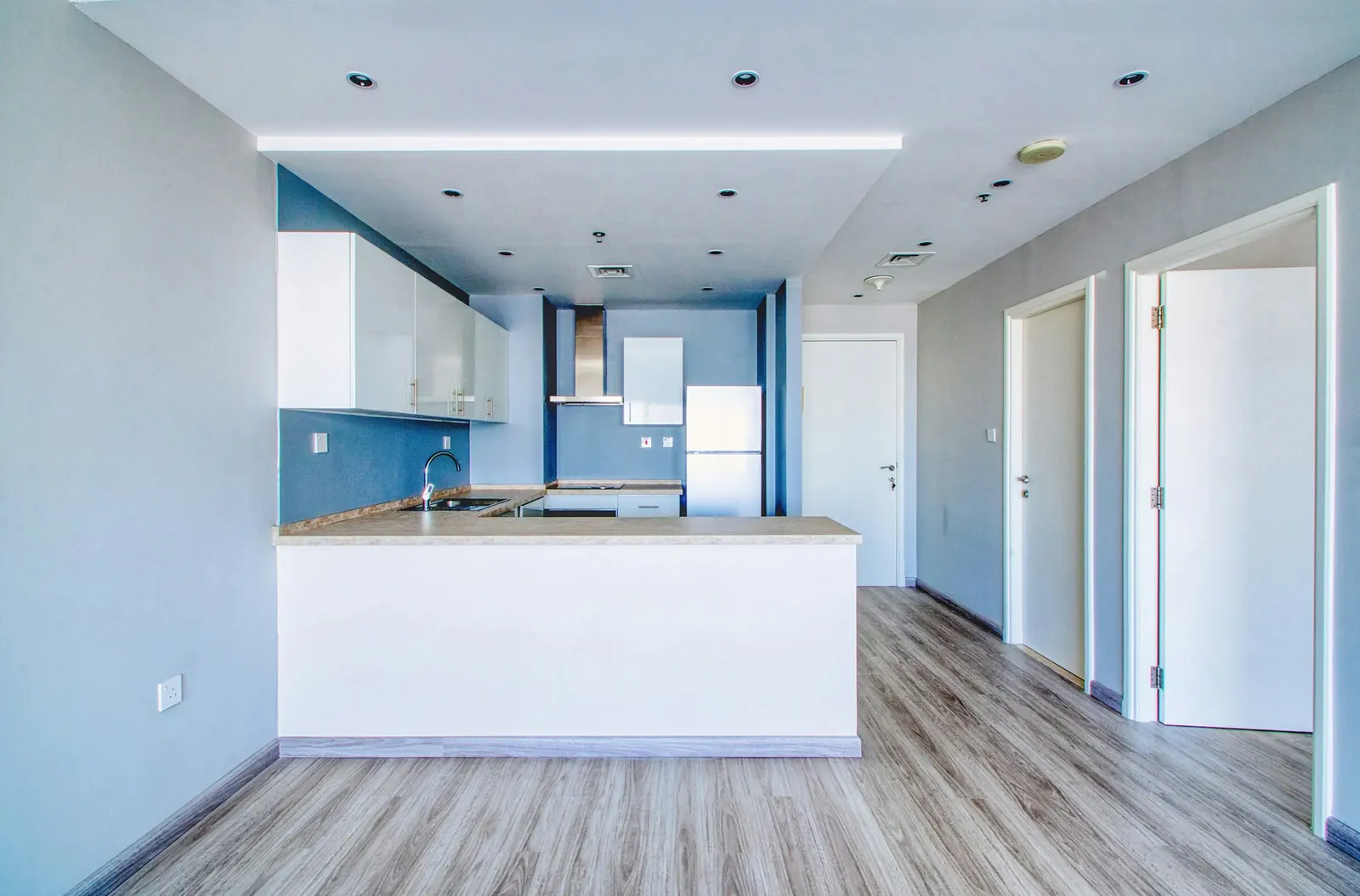 A newly finished kitchen and living space, empty and bright